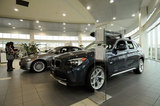 25 November 2011 - People look at automobiles in the showroom of Auto West BMW, in Richmond, B.C., Canada. Credit: Adrian Brown - N49Photo.