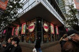 22 November 2011 - People pass an HMV store location advertising a closing sale, at the corner of Burrard and Robson Streets, in Vancouver, B.C., Canada. Credit: Adrian Brown - N49Photo.