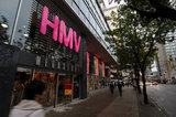 22 November 2011 - People pass an HMV store location advertising a closing sale, at the corner of Burrard and Robson Streets, in Vancouver, B.C., Canada. Credit: Adrian Brown - N49Photo.