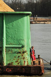 09 April 2012 - A tug boat crew member prepares to join two barges together, beside a log mill on the Fraser River, in Surrey, B.C., Canada. Credit: Adrian Brown - N49Photo.