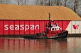 09 April 2012 - A tug boat crew prepares to join two barges together, beside a log mill on the Fraser River, in Surrey, B.C., Canada. Credit: Adrian Brown - N49Photo.