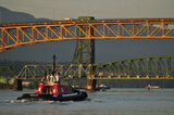 07 May 2012 - The Seaspan Ship Assist Harbour Tug, Seaspan Hawk, is seen near the Ironworkers Memorial Bridge, as it positions itself to help move a cargo ship away from the Cascadia grain terminal, in Vancouver, B.C., Canada. Credit: Adrian Brown - N49Photo.
