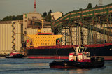 07 May 2012 - The Seaspan Ship Assist Harbour Tug, Seaspan Hawk, (background) and Charles H. Cates III move into position to help move a cargo ship away from the Cascadia grain terminal, in Vancouver, B.C., Canada. Credit: Adrian Brown - N49Photo.