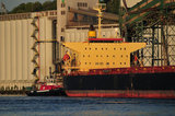 07 May 2012 - The Seaspan Ship Assist Harbour Tug, Seaspan Hawk, helps move the cargo ship, St. Nikon, away from the Cascadia grain terminal, in Vancouver, B.C., Canada. Credit: Adrian Brown - N49Photo.
