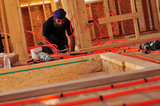 20 September 2012 - Ranjit Singh Sandhu installs Radiant PEX tubing on the second floor of a new home, where it will be used in the property's Hydronic Radiant Floor Heating system, at a construction site in Surrey, B.C., Canada. Credit: Adrian Brown - N49Photo.