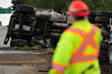 05 November 2012 - An overturned truck is seen at the side of Highway 99, in Surrey, B.C., Canada. While an investigation will take place, it is believed that the right front tire of the truck blew out, causing the truck to veer off the shoulder, rolling onto its side in a grassy area beside the highway. The driver was unhurt at the scene. Credit: Adrian Brown - N49Photo.